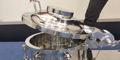 Someone lifting a spring assisted lift from their mixing equipment